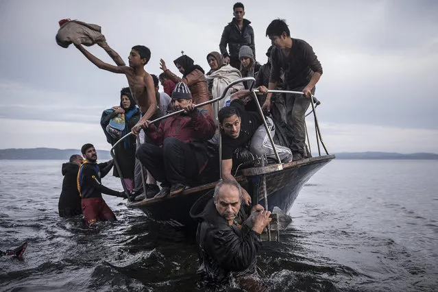 A handout image provided by the World Press Photo (WPP) organization on 18 February 2016 shows a picture by Russian photographer Sergey Ponomarev for The New York Times that won First Prize Stories in the General News Category of the 59th annual World Press Photo Contest, it was announced by the WPP Foundation in Amsterdam, The Netherlands on 18 February 2016. The picture shows migrants and refugees arrived by boat in November 2015 near the village of Skala on the Greek island of Lesbos. Under Europe's system of open internal borders, the island's thinly patrolled, easily accessible coastline, within sight of the Turkish coast, might as well be the frontier of France or Germany or Sweden. (Photo by Sergey Ponomarev/World Press Photo Contest/EPA)