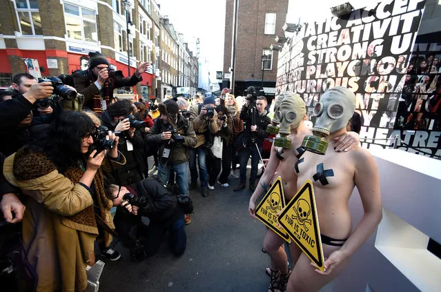 PETA protesters wearing gas maks demonstrate outside the London Fashion Week against the use of fur in London, Britain, 19 February 2016. The Fall/Winter 2016 collections are presented from 19 to 23 February. (Photo by Facundo Arrizabalaga/EPA)