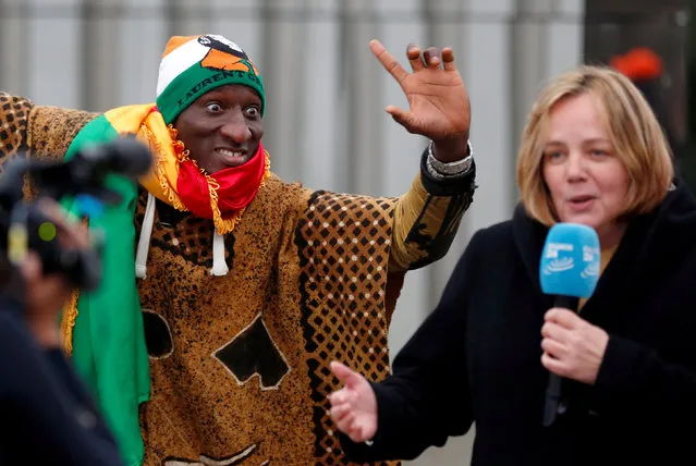 A supporter of former Ivory Coast President Laurent Gbagbo celebrates outside the International Criminal Court in The Hague, Netherlands, February 1, 2019. (Photo by Eva Plevier/Reuters)