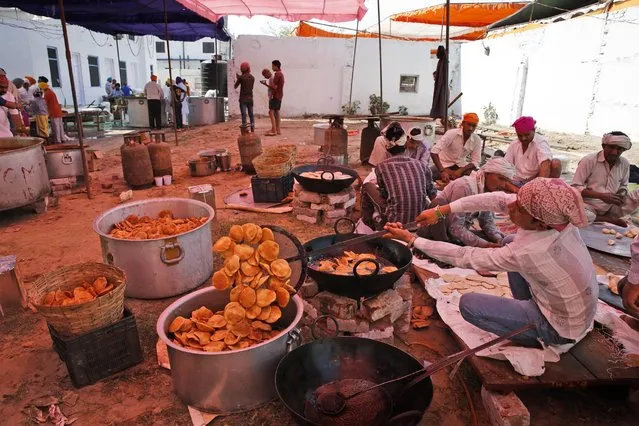 Indian Sikhs prepare food for devotees at a Sikh temple on Baisakhi, in New Delhi, India, Tuesday, April 14, 2015. (Photo by Manish Swarup/AP Photo)