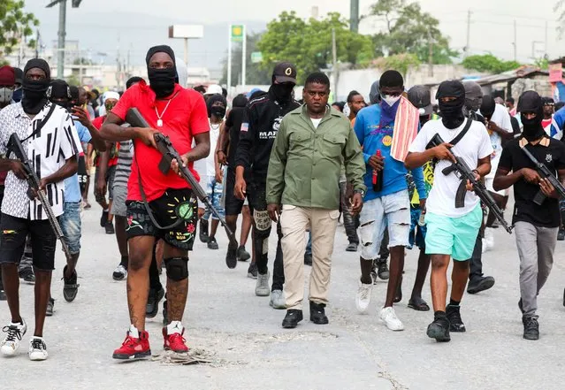 Former police officer Jimmy “Barbecue” Cherizier, leader of the 'G9' coalition, leads a march surrounded by his security against Haiti's Prime Minister Ariel Henry, in Port-au-Prince, Haiti on September 19, 2023. (Photo by Ralph Tedy Erol/Reuters)