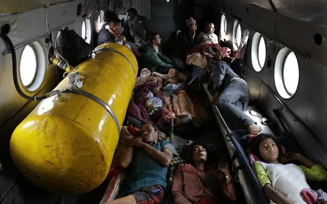 Nepalese victims of Saturday's earthquake lie inside an Indian air force helicopter as they are evacuated from Trishuli Bazar to Kathmandu airport in Nepal, Monday, April 27, 2015. (Photo by Altaf Qadri/AP Photo)