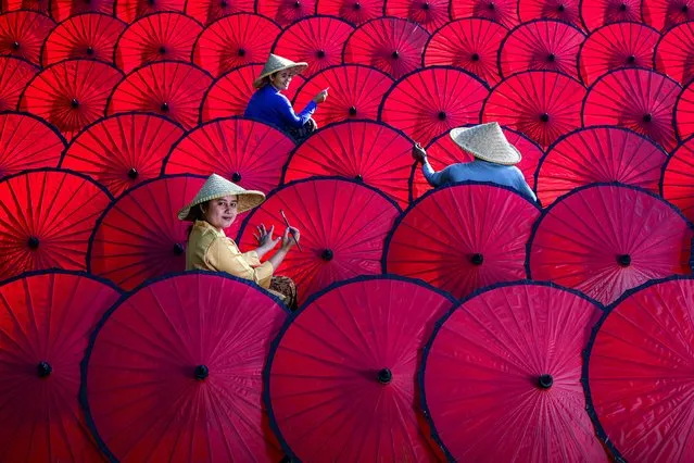 Workers creating colourful traditional umbrellas from paper in the Indonesian province of West Java on September 19, 2021. (Photo by Farida Rasiti/Solent News)