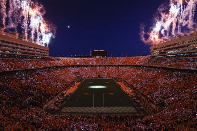 Fans dressed in orange and white form the checkerboard pattern in Neyland Stadium as fireworks explode before an NCAA college football game against Mississippi Saturday, October 16, 2021, in Knoxville, Tenn. (Photo by Wade Payne/AP Photo)