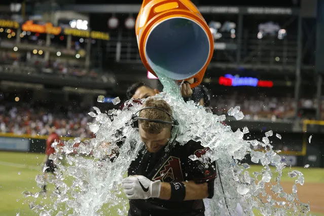 Arizona Diamondbacks' Carson Kelly is doused after hitting a walkoff single to defeat the Boston Red Sox in a baseball game, Saturday, April 6, 2019, in Phoenix. (Photo by Rick Scuteri/AP Photo)