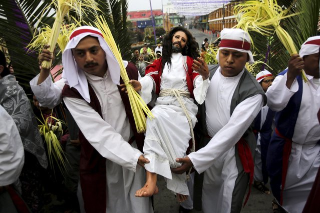 Men carry a statue of Jesus Christ during a Catholic Palm Sunday procession on the streets of San Pedro Sacatepequez, Guatemala, March 20, 2016. (Photo by Saul Martinez/Reuters)