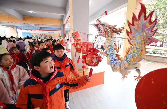 Students view paper-cut lanterns and other paintings at Hairong Primary School in Xiangyang City, central China's Hubei Province, February 26, 2024. The new semester for primary and secondary schools kicked off in many parts of China on Monday. (Photo by Xinhua News Agency/Rex Features/Shutterstock)