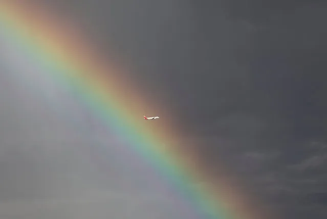 An Iberia passenger plane flies past a rainbow after taking off from Adolfo Suarez Barajas airport in Madrid, Spain October 9, 2018. (Photo by Sergio Perez/Reuters)