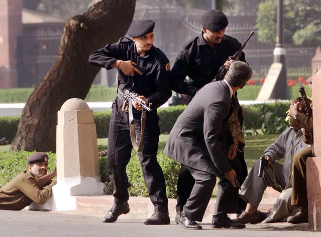 Indian Black Cat commandos escort civilians outside the Parliament House as half a dozen armed men stormed the complex in New Delhi, India, Dec. 13, 2001. India on Friday, August 12, 2022, criticized China's decision to block the imposition of U.N. sanctions sought by it and the United States against Abdul Rauf Azhar, the deputy chief of Jaish-e-Mohammad, a Pakistan-based extremist group designated by the United Nations as a terrorist organization. India says Azhar was involved in the planning and execution of numerous terror attacks, including the 2001 attack on the Indian Parliament. (Photo by John McConnico/AP Photo/File)