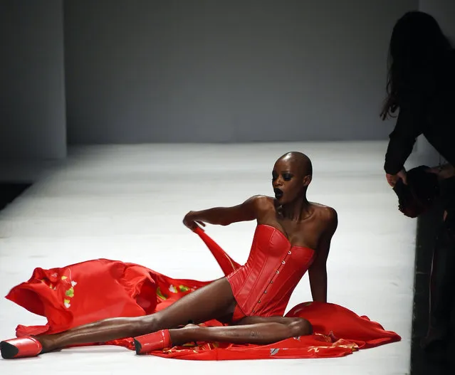 A model falls over on the runway at SECCRY Hu Sheguang Collection 2014 Show during Mercedes-Benz China Fashion Week Autumn/Winter 2014/2015 at the 751D-PARK Central Hall on March 30, 2014 in Beijing, China. (Photo by ChinaFotoPress/ChinaFotoPress via Getty Images)