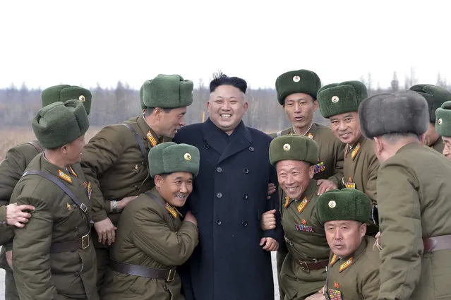North Korean leader Kim Jong Un (C) smiles as he stands with commanding officers of the combined units of the Korean People's Army (KPA) in this undated photo released by North Korea's Korean Central News Agency (KCNA) in Pyongyang April 2, 2014. (Photo by Reuters/KCNA)