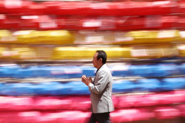 A man walks around while praying in front of lotus lanterns attached to prayer petitions at Jogye temple in Seoul, South Korea, on May 8, 2024. (Photo by Kim Hong-Ji/Reuters)