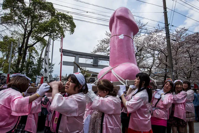 A large pink phallic-shaped “Mikoshi” is paraded through the streets during Kanamara Matsuri (Festival of the Steel Phallus) on April 6, 2014 in Kawasaki, Japan. The Kanamara Festival is held annually on the first Sunday of April. The pen*s is the central theme of the festival, focused at the local pen*s-venerating shrine which was once frequented by prostitutes who came to pray for business prosperity and protection against sexually transmitted diseases. (Photo by Chris McGrath/Getty Images)
