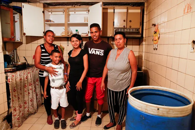 Francisca Landaeta (R) poses for a picture next to her relatives, (L-R) Luisa Gomez, Gabriel Castillo, Kerlin Garrido and Antony Arias, at their home in Caracas, Venezuela April 14, 2016. “We eat today, but we do not know what we will eat tomorrow. We are bad, I never thought it would come to this”, Landaeta said. (Photo by Carlos Garcia Rawlins/Reuters)