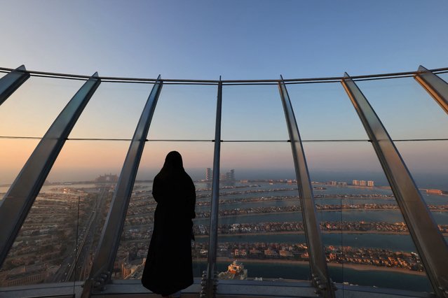 A woman stands at “the View at Palm” overlooking the Palm Jumeirah in the Gulf emirate of Dubai on January 10, 2022. (Photo by Giuseppe Cacace/AFP Photo)
