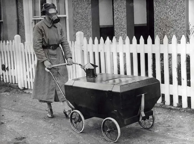 A resident of Hextable in Kent, invented a gas proof pram in which a baby could be kept safe during an air raid. The pram has an air-tight lid provided with a window and with a gas mask filter. A rubber bulb at the rear is squeezed at intervals forcing the stale air out and replacing it with fresh air drawn in through the filter. Date: 1938. (Photo by Mary Evans Picture Library/Caters News)