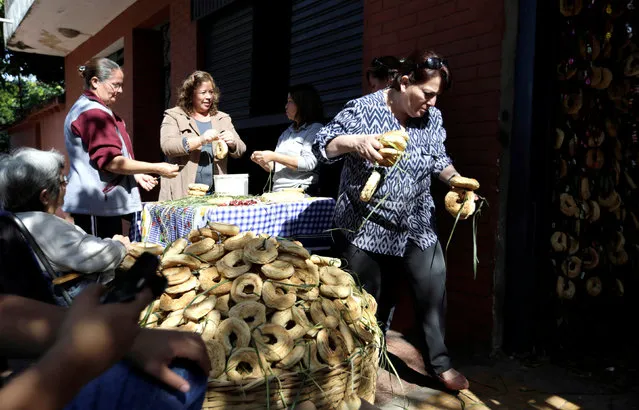 The Antar family prepare traditional cheese and corn buns called chipas, in celebration of the Catholic festival Kurusu Ara (The Day of the Cross), in Asuncion, Paraguay May 3, 2016. (Photo by Jorge Adorno/Reuters)