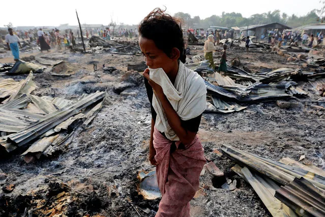 A woman walks among debris after fire destroyed shelters at a camp for internally displaced Rohingya Muslims in the western Rakhine State near Sittwe, Myanmar May 3, 2016. (Photo by Soe Zeya Tun/Reuters)