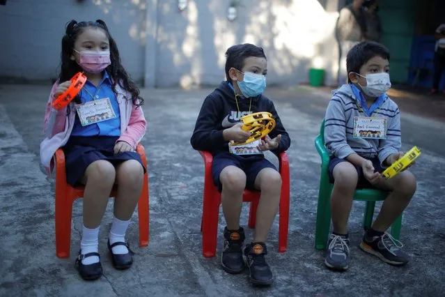 Students wearing protective face masks are seated adhering to social distancing guidelines while attending a class, as students return to classes for 2022 school year, amid the coronavirus disease (COVID-19) pandemic, in San Salvador, El Salvador on January 31, 2022. (Photo by Jose Cabezas/Reuters)