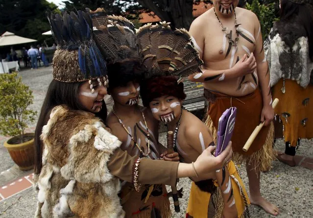 Members of the Costanoan Rumsen Carmel Tribe of the Ohlone Nation take a selfie during Founder's Day at the Carmel Mission in Carmel, California, June 28, 2015. The Mission was founded by Franciscan friar Junipero Serra in 1771. The Ohlone people inhabited the central coast of California when the Spanish missionaries arrived. (Photo by Michael Fiala/Reuters)