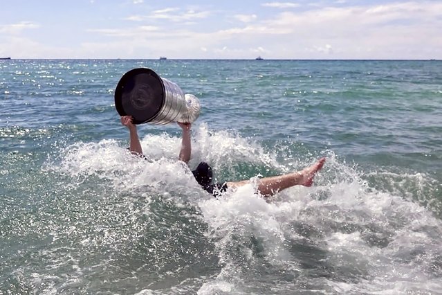 Florida Panthers NHL hockey player Matthew Tkachuk takes the Stanley Cup into the Atlantic Ocean in Fort Lauderdale, Fla., Tuesday, June 25, 2024. The Panthers beat the Edmonton Oilers 2-1 on Monday night in Game 7 of the Stanley Cup Final. (Photo by Joe Cavaretta/South Florida Sun-Sentinel via AP Photo)