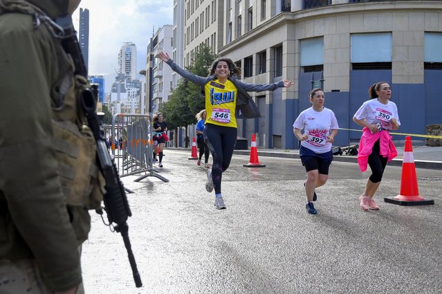 Women take part in the 9th edition of Women's Race 2023, a ten kilometer run in Beirut, Lebanon, 19 March 2023. Around 1,500 runners participated in the Women's Race under the slogan “Draw Your Path”. The event was organized to address all Lebanese women to keep moving forward and to rise to the challenges of every day. (Photo by Wael Hamzeh/EPA)