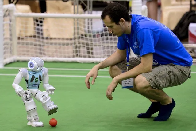 A participant tests a robot soccer player before a competition at the RoboCup 2015, at an exhibition centre in Hefei, Anhui province, China, July 19, 2015. (Photo by Reuters/Stringer)