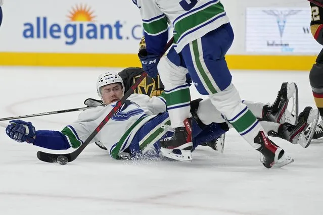Vancouver Canucks left wing Juho Lammikko (91) falls across the ice during the second period of an NHL hockey game against the Vegas Golden Knights, Wednesday, April 6, 2022, in Las Vegas. (Photo by John Locher/AP Photo)