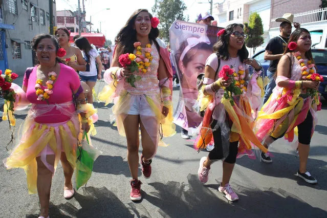 Activist Diana Ceballos, second left, takes part in a procession for felled women like her 14-year old cousin, in Ecatepec, a suburb of Mexico City, Saturday, November 23, 2019. Ceballos' cousin was raped and stabbed to death by an ex-boyfriend of the teenager’s mother. He confessed via text message to the mother immediately after the 2014 murder. Even so, it took three years to clinch a jail sentence against the perpetrator. (Photo by Alicia Fernandez/AP Photo)