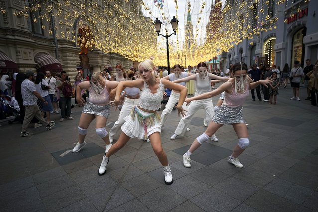 Young Russian women dance to the music of Soojin on the pedestrian of Nikolskaya street near Red Square and the Kremlin in Moscow, Russia, Thursday, July 18, 2024. Seo Soo-jin, better known mononymously as Soojin, is a South Korean singer, dancer, and rapper, who has many fans in Russia. (Photo by Alexander Zemlianichenko/AP Photo)