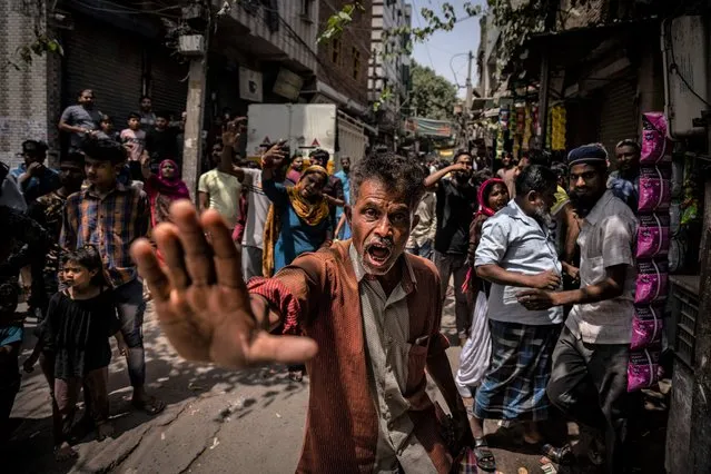 An agitated Muslim resident asks media to leave alleging them of distorting facts, during the demolition of Muslim-owned shops at the site of Saturday's communal violence, in New Delhi's northwest Jahangirpuri neighborhood, in New Delhi, India, Wednesday, April 20, 2022. Authorities riding bulldozers razed a number of Muslim-owned shops in New Delhi before India's Supreme Court halted the demolitions Wednesday, days after communal violence shook the capital and saw dozens arrested. (Photo by Altaf Qadri/AP Photo)