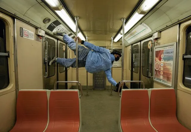 Dance instructor Rodolfo Robles rehearses in a subway while traveling to a friend´s house to prepare for a performance, in Santiago, Chile, Tuesday, September 21, 2021. (Photo by Esteban Felix/AP Photo)