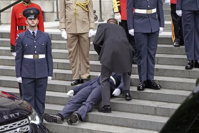 A Military personnel faints ahead of service of thanksgiving for the reign of Queen Elizabeth II at St Paul’s Cathedral in London, Friday June 3, 2022 on the second of four days of celebrations to mark the Platinum Jubilee. The events over a long holiday weekend in the U.K. are meant to celebrate the monarch’s 70 years of service. (Photo by Kirsty O'Connor, Pool Photo via AP Photo)