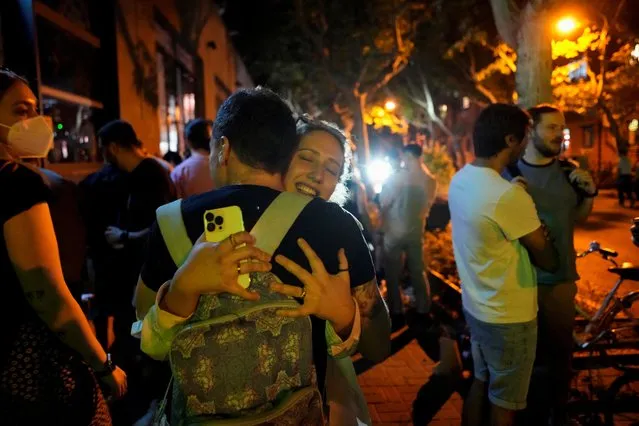People hug on a street, as the city prepares to end the lockdown placed to curb the coronavirus disease (COVID-19) outbreak in Shanghai, China on May 31, 2022. (Photo by Aly Song/Reuters)