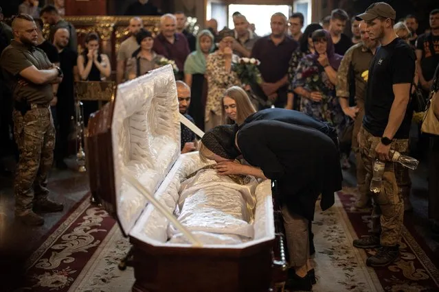 Family and friends attend a memorial service for Ukrainian serviceman Ivan Chekaniuk, who died during a combat mission in Sievierodonetsk, at St. Michael's Golden-Domed Cathedral in central Kyiv, Ukraine on June 11, 2022. (Photo by Marko Djurica/Reuters)