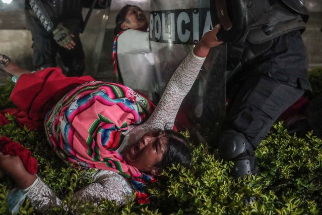 Anti-government protesters gathered in San Martin square clash with members of the Police at the end of a day of protests, in Lima, Peru on July 22, 2023.A new march was called in Lima by social and union organizations to demand the resignation of Peruvian President Dina Boluarte and the closure of the National Congress. (Photo by Aldair Mejia/EPA/EFE)