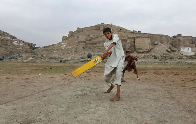 Afghan children play cricket on the outskirts of Kabul, Afghanistan, Monday, August 3, 2015. (Photo by Rahmat Gul/AP Photo)