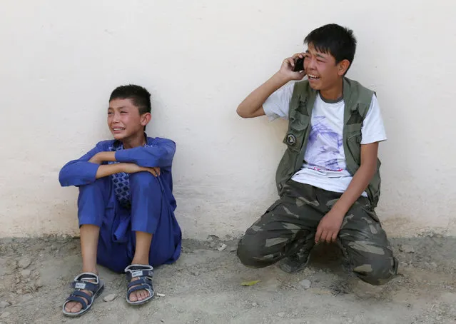 Afghan boys mourn at the site of a suicide attack followed by a clash between Afghan forces and insurgents after an attack on a Shi'ite Muslim mosque in Kabul, Afghanistan on Friday, August 25, 2017. (Photo by Mohammad Ismail/Reuters)