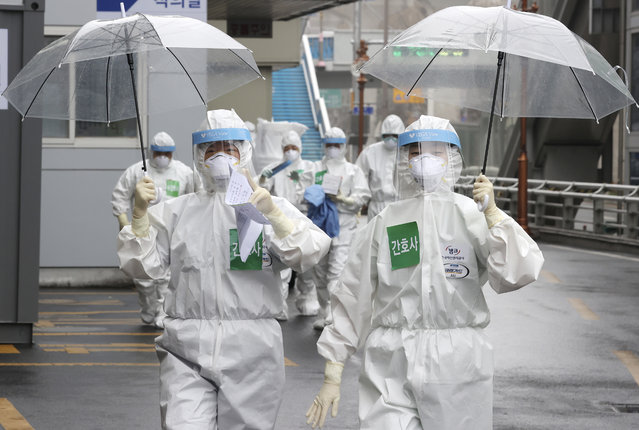 Medical staff members arrive for a duty shift at Dongsan Hospital in Daegu, South Korea, Friday, March 27, 2020. (Photo by Lee Yong-hwan/Newsis via AP Photo)