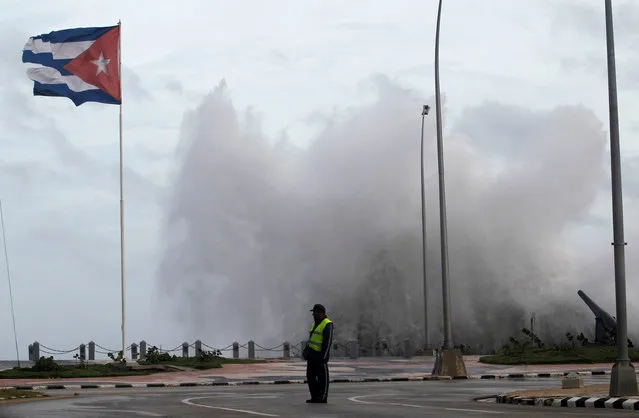 A police officer stands on the seafront boulevard El Malecon ahead of the passing of Hurricane Irma, in Havana, Cuba September 9, 2017. (Photo by Reuters/Stringer)