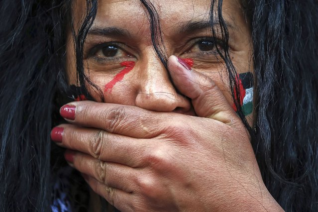A protester takes part in a minutes silence during a demonstration organized by the “National Collective for a just and lasting peace between Palestinians and Israelis” in Paris, Sunday, October 22, 2023. (Photo by Aurelien Morissard/AP Photo)
