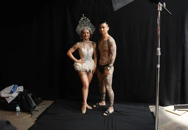 Tattoo enthusiasts pose for photographs during the London Tattoo Convention at the Tobacco Docks, in London, Britain, 24 September 2017. (Photo by Facundo Arrizabalaga/EPA/EFE)