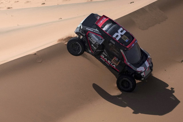 Driver Nasser Al-Attiya, and co-driver Edouard Boulanger compete during the eighth stage of the Dakar Rally between Al Duwadimi and Riyadh, Saudi Arabia, Monday, January 13, 2025. (Photo by Christophe Ena/AP Photo)