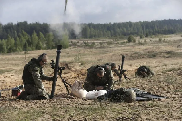 Danish troops fire grenade as they take part in live fire exercise in a tactical environment ahead of “Silver Arrow” drill in Adazi training field, Latvia,  September 5, 2015. (Photo by Ints Kalnins/Reuters)