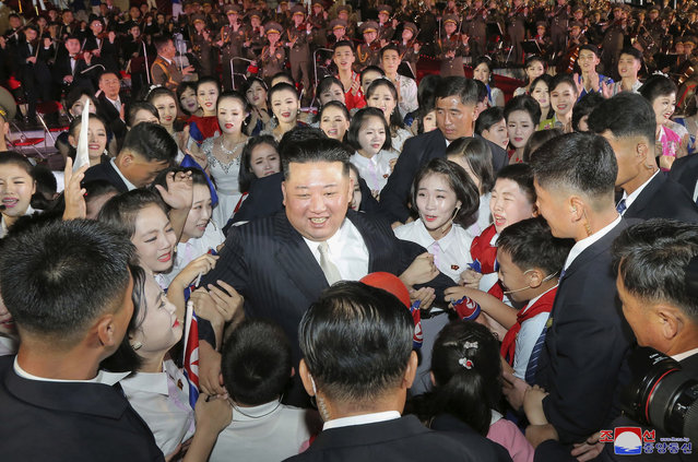 This photo provided by the North Korean government shows North Korean leader Kim Jong Un, center, is surrounded by performers during a celebration marking the nation's 74th anniversary in Pyongyang, North Korea, on September 8, 2022. (Photo by Korean Central News Agency/Korea News Service via AP Photo)