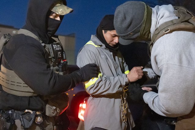 U.S. Immigration and Customs Enforcement officers use a chain to more comfortably restrain a detained person using handcuffs positioned in front, Monday, January 27, 2025, in Silver Spring, Md. (Photo by Alex Brandon/AP Photo)
