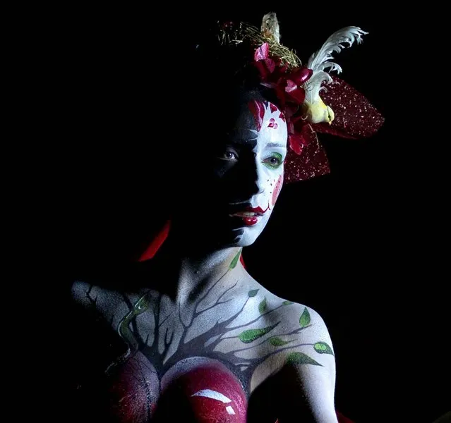A model shows her body paintings drawn during the night of body art in Moscow, on September 30, 2012. (Photo by Alexander Zemlianichenko/Associated Press)