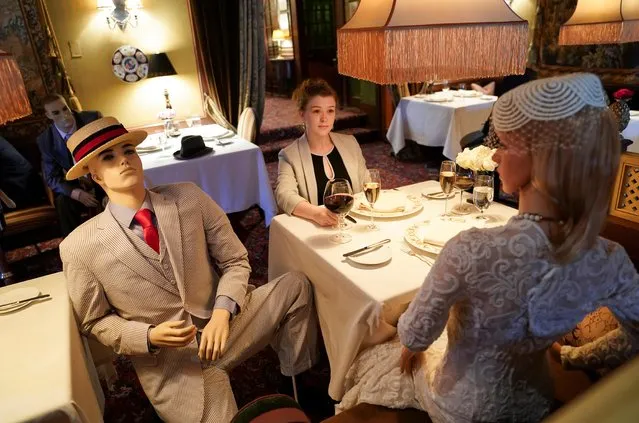 Executive Assistant Jessie Dawson sits among mannequins occupying some tables so diners will not feel isolated by coronavirus social distancing measures when The Inn at Little Washington, a Michelin three-star restaurant, reopens shortly in Washington, Virginia, May 20, 2020. (Photo by Kevin Lamarque/Reuters)