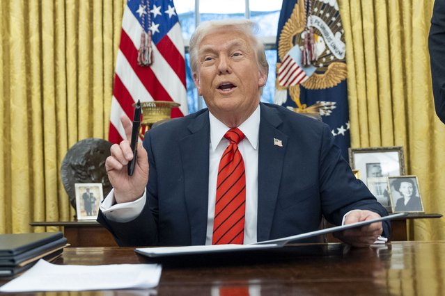 President Donald Trump speaks with reporters as he signs executive orders in the Oval Office at the White House, Monday, February 10, 2025, in Washington. (Photo by Alex Brandon/AP Photo)