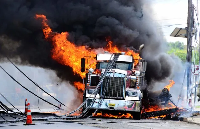 A dump truck burns after it pulled down utility lines in Teterboro, N.J., on September 22, 2014. (Photo by Tariq Zehawi/The Record of Bergen County)